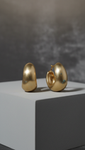 Muted gold sculptural hoop earrings